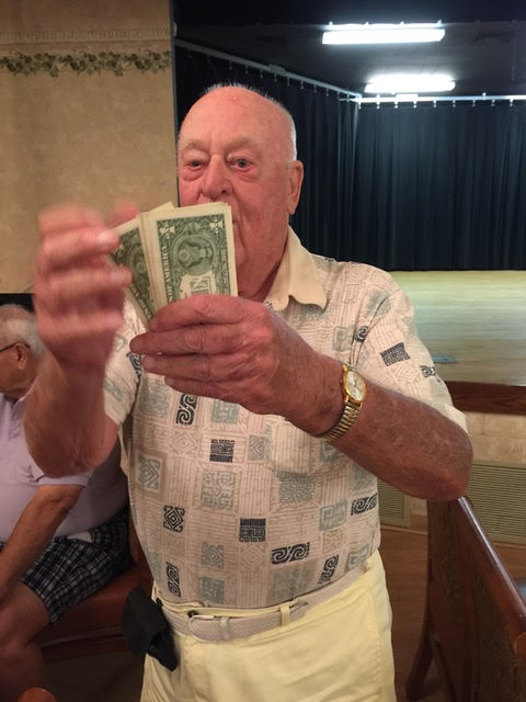 Old Friends Club member counts his winnings after getting a hole-in-one
