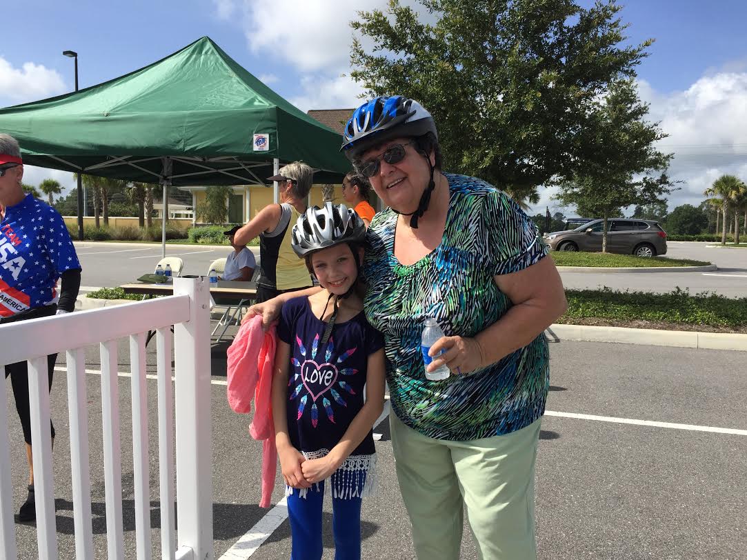 Villager Val Stadnek and her 9-year-old granddaughter enjoying their free helmets at the Bike Rodeo