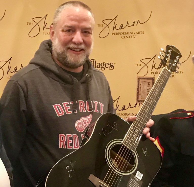 Man visiting parents in The Villages wins autographed guitar at Kansas concert at The Sharon