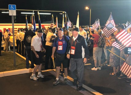 Cheering crowd welcomes home veterans returning on Villages Honor Flight