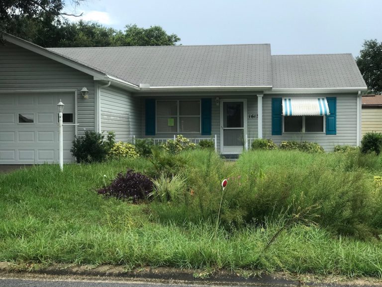 Grass and weeds overgrown at dead man’s home in foreclosure on Historic Side of Villages