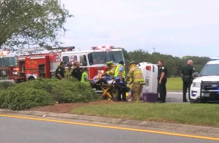 Firefighters extricate woman from vehicle after rollover crash on County Road 466