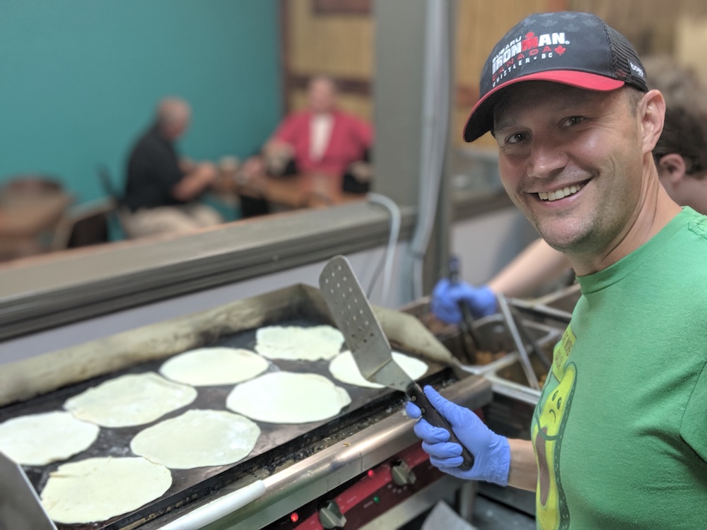Scott Snyder, owner of Papa Pineapples, flipping handmade flour tortillas