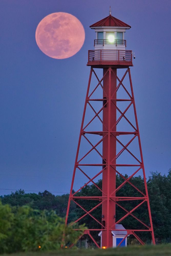 Super Pink Moon Rising Over Lake Sumter's Lighthouse