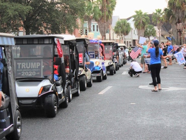 Trump backers clash with Biden loyalists during massive golf cart parade