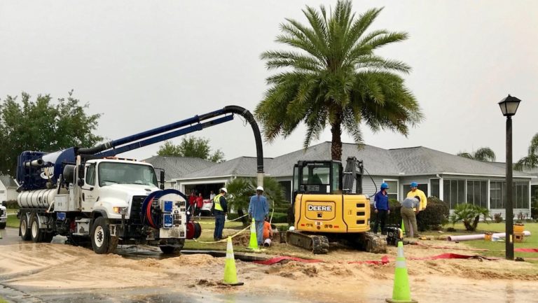 A utility crew worked to repair a water main break at Evander Avenue and Montbrook Place in the Village of Tamarind Grove