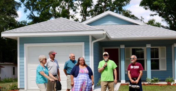 Joyce Tohill center recived the keys to her new home from members of The Villagers Habitat for Humanity Club