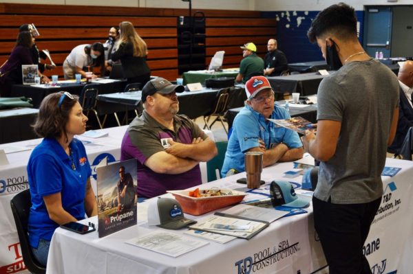 South Sumter student Miquel Montijo meets with Nate Yoder and team from T and D Pools at Sumter Senior Hiring Fair