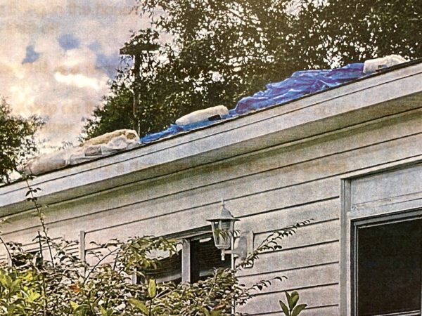 A tarp on the roof of a house at 17479 SE 82nd Pecan Terrace.