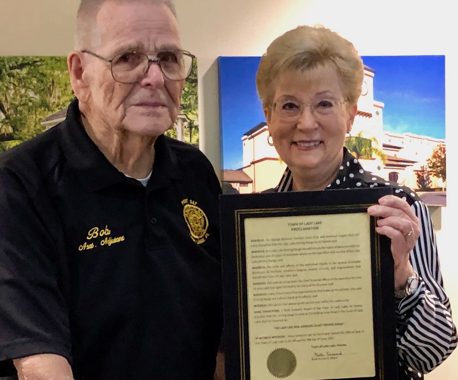 Lady Lake Mayor Ruth Kussard with the proclomation honoring Bob Johnson