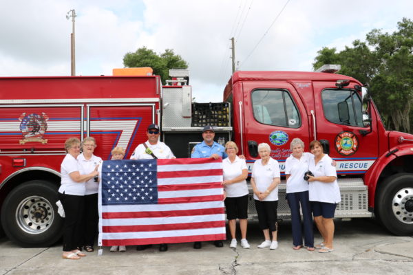 Water Oak Veterans Auxiliary presents a new flag Firefighters to Ryan Fickett and Anthony Boremans .