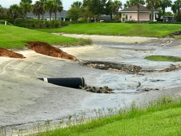 Sinkholes drained a pond behind the Moyer Recreation Center in The Villages Sinkholes drained a pond behind the Moyer Recreation Center in The Villages
