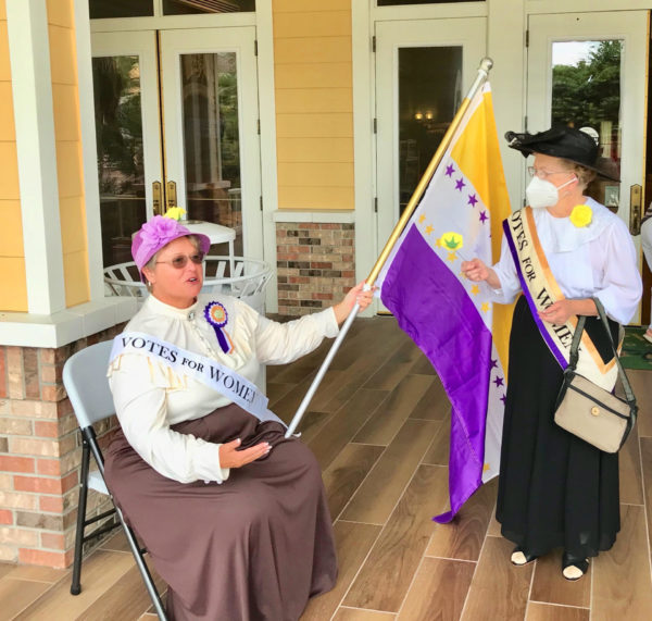 Cathy Hale and Noni Gauder greeted Villagers to the Sisters of Suffrage celebration .