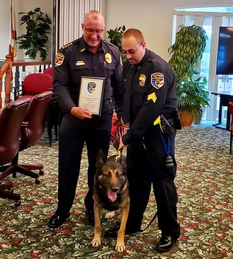 K 9 Barry was honored by Police Chief Randy Parmer left. He will live out his remaining years as a pet with his handler Sgt. Richard Parrish