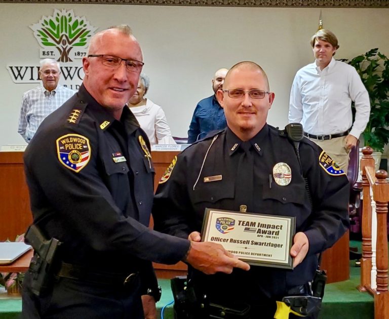 Wildwood Police Chief Randy Parmer left presents the Officer of the Quarter award to officer Russell Swartzfager 2