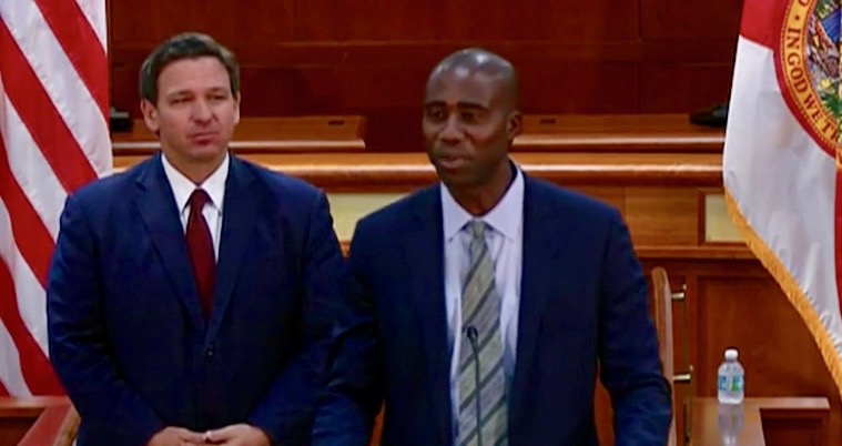 Dr. Joseph Ladapo center was introduced Tuesday as Floridas new surgeon general looks on