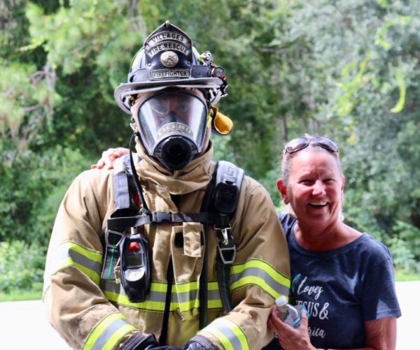Villager Nancy Schoenacher with a fully equipped Villages fire rescue officers. Villager Nancy Schoenacher with a fully equipped Villages fire rescue officers.