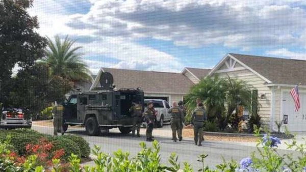 A Villager shot this photo of the SWAT team through her screen window