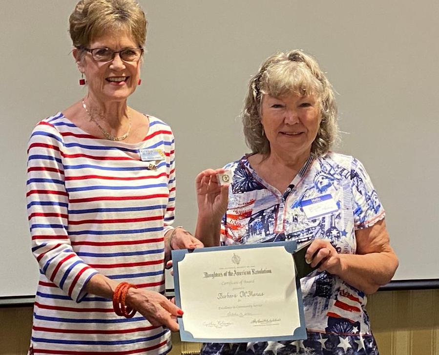 Executive Board Member Nathalie Heydet left presents Barbara McManus of the Wildwood Soup Kitchen with the award.