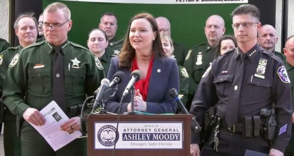 Attorney General Ashley Moody center is flanked by Lake County Sheriff Peyton Grinnell and Lady Lake Police Chief Robert Tempesta
