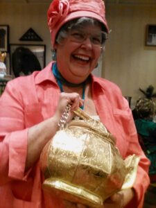 Arlene Eckhardt president of the Sunday Tea Club displays a gold teapot Arlene Eckhardt president of the Sunday Tea Club displays a gold teapot