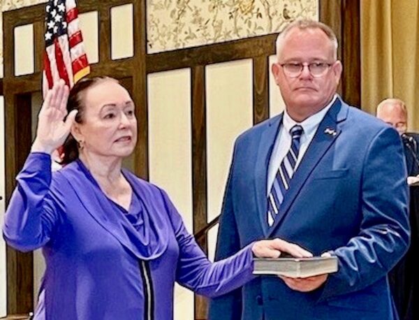 County Administrator Bradley Arnold held the Bible as Diane Spencer took the oath of office