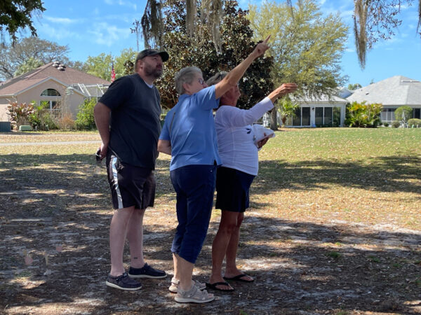 Rosalie Rutkowski far right helps point out the location of an owl