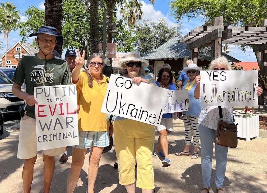 Villager Bill Sayer far left organized the small rally at Lake Sumter Landing