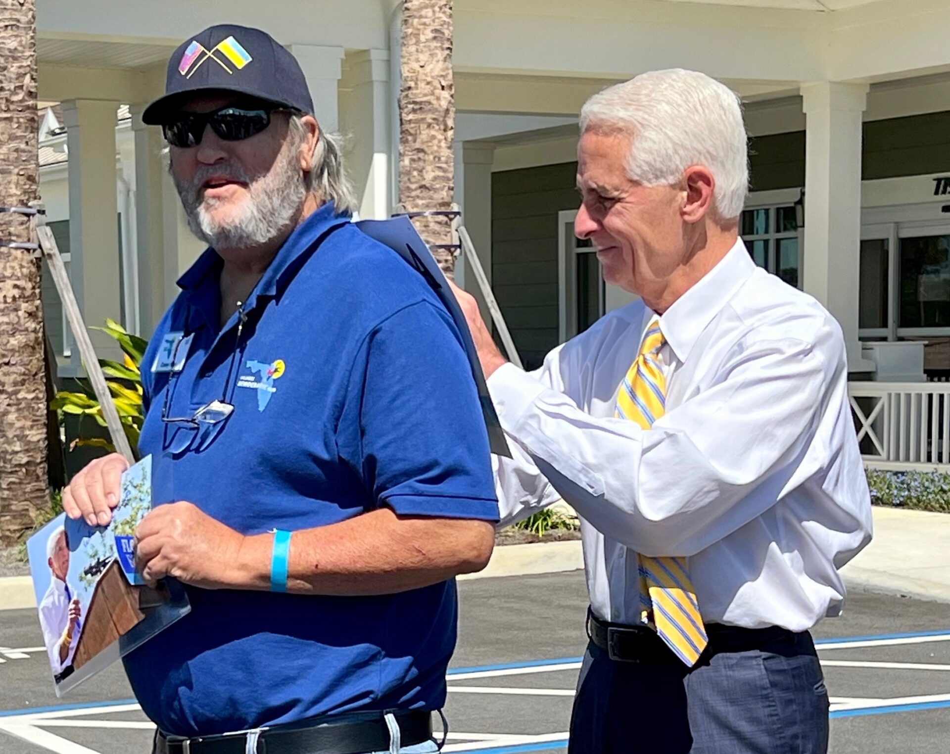 Charlie Crist right signs an autograph for Villager Casey Marr