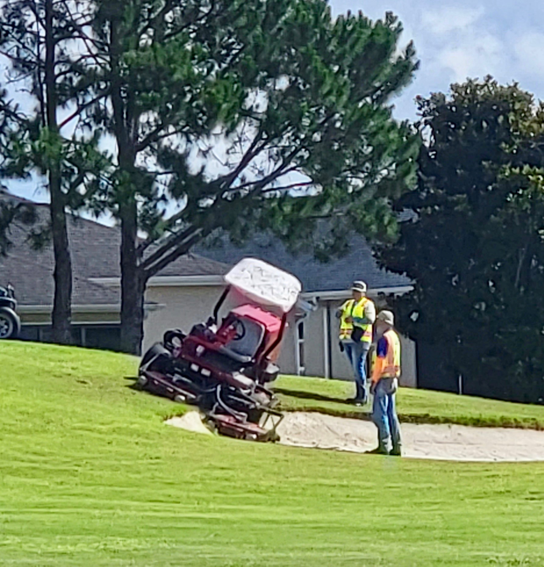 A mower was partially lodged in a sand trap Tuesday afternoon at Havana Championship Golf Course
