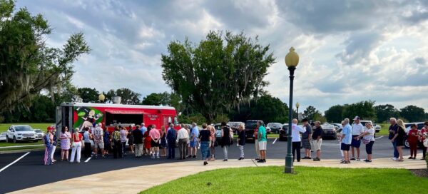 Those attending the Laura Loomer event lined up at a food truck in advance of the Congressional candidate taking the stage at the Wildwood Community Center.