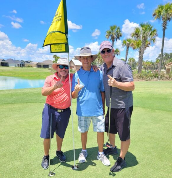 Jim Mahlmann center got his first hole in one while golfing in The Villages