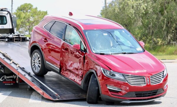 The Lincoln with the broken axle was towed from the scene of the crash The Lincoln with the broken axle was towed from the scene of the crash