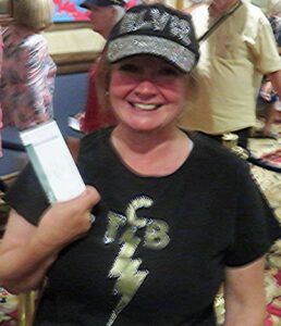 Villager Melissa Flores came to see the Elvis movie Thursday with her special hat and shirt as she holds here ticket