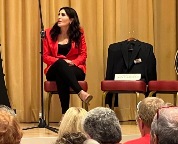 Candidate Laura Loomer used an empty suit on a chair to drive home Congressman Daniel Websters absence at Tuesdays forum in The Villages