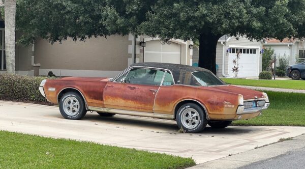 A resident complained about this rusty car parked in a driveway in his neighborhood