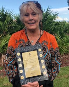 Lady Lake Finance Director Pam Winegardner holds the plaque from the Government Finance Officers Association