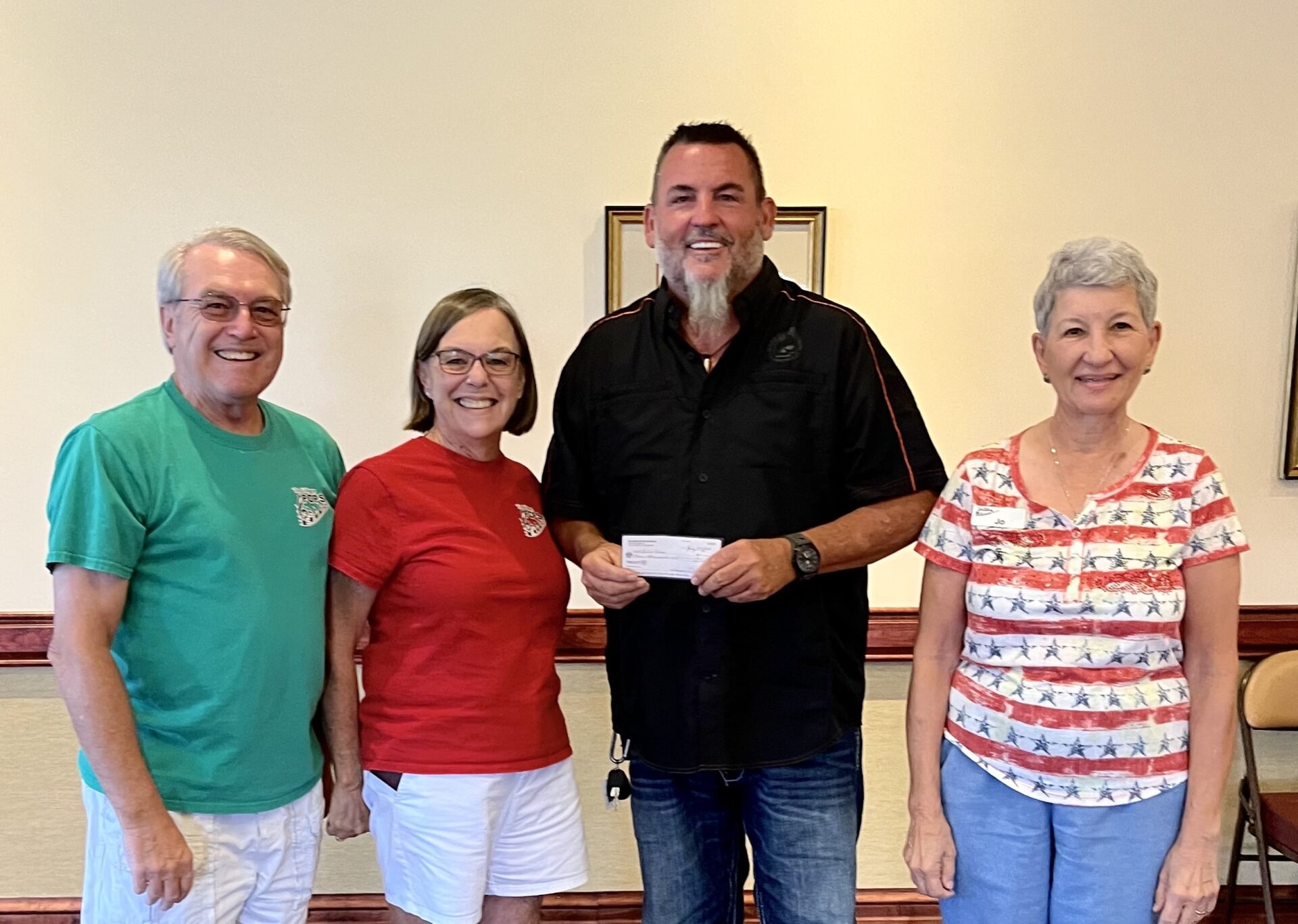 Pastor David Houck of SoZo Kids third from right accepts a 4000 check from The Villages Pops Chorus.