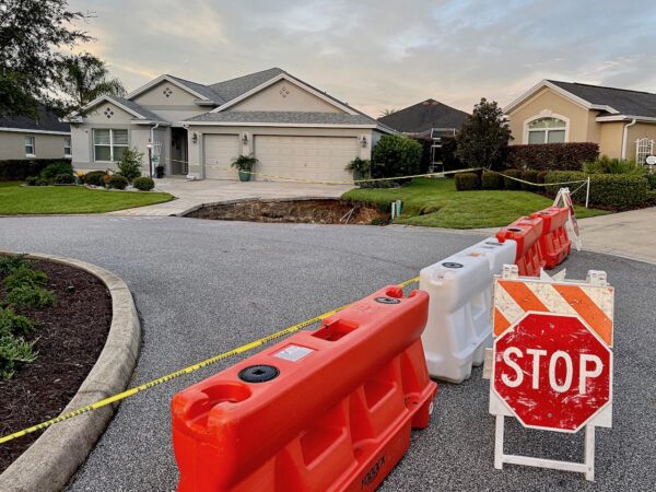 A barrier was set up to keep traffic away from the sinkhole located near the end of a driveway in the Village of Fernandina