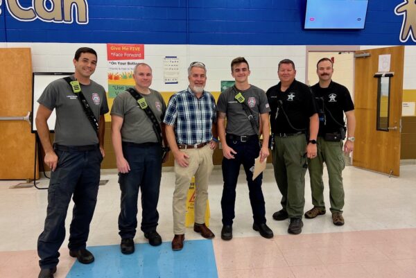 Principal Gregg Duddley center with Lake County Fire and rescue personeelland Lake County Sheriffs deputies