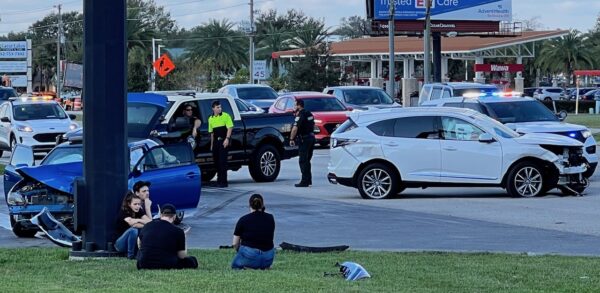 Four young people seen at lower right corner of photo had been riding in one of the vehicles Four young people seen at lower right corner of photo had been riding in one of the vehicles