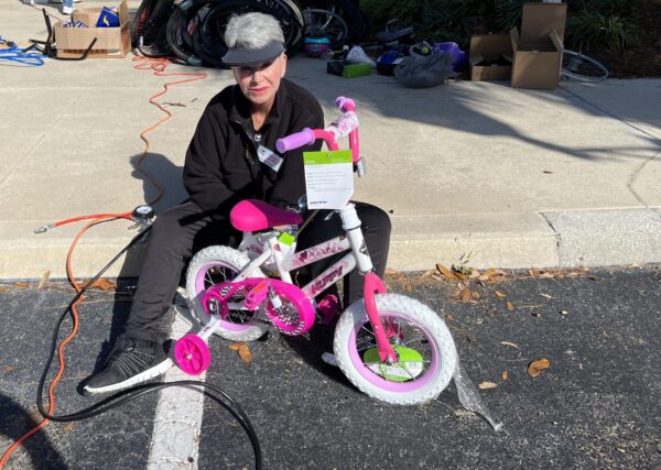 Villager Rose Jordan finishes up work on a childs dream bike.