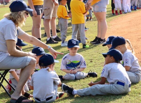 A coach gave last minute instructions to players prior to the opening game of Little League in Lady Lake