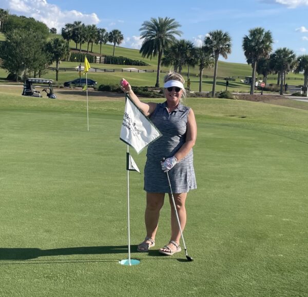 Corinne Zdanuk celebrated after getting a hole in one