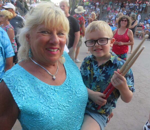 Duke Leapaldt is a young Rollers fans flashing his drumsticks as Gramma Georgia Halvorson looks on