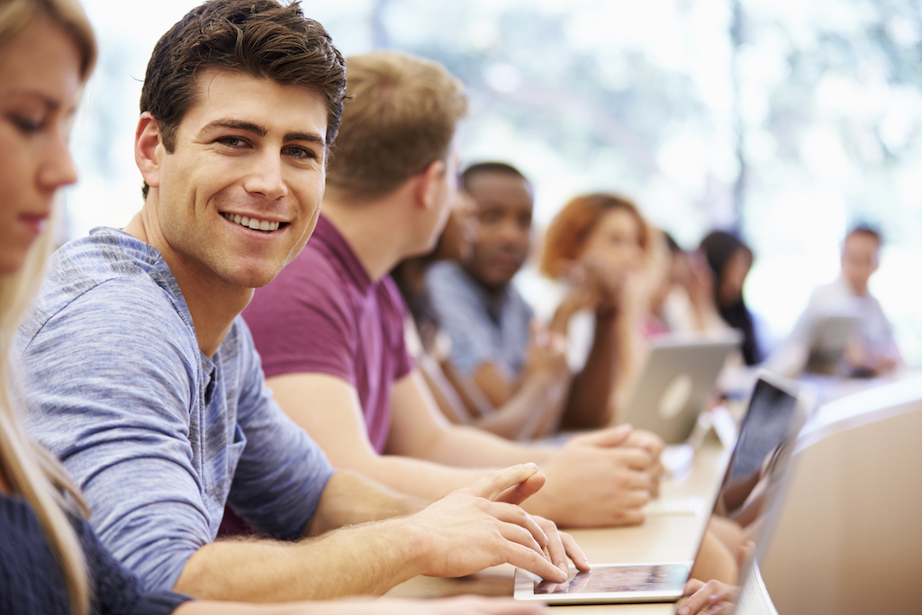 Class Of University Students Using Laptops In Lecture