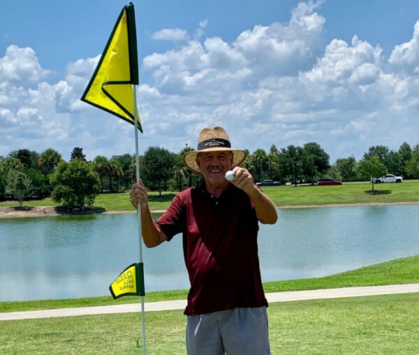 David Cochran shows off his golf ball after getting a hole in one