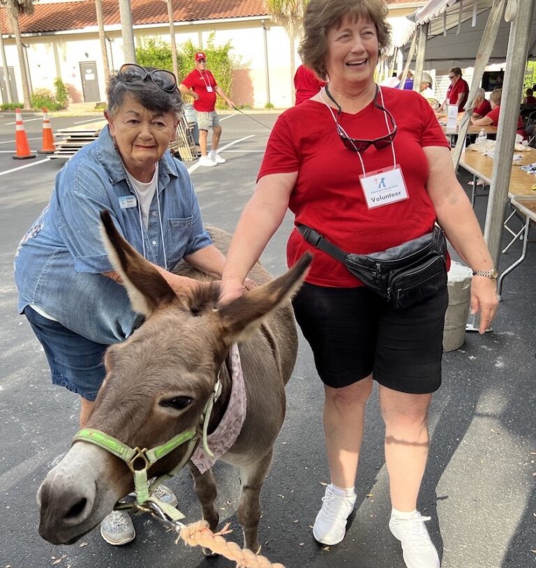 Ilene Hintzen on the left and Nancy Beaverson enjoyed meeting Jesse, the miniature donkey.