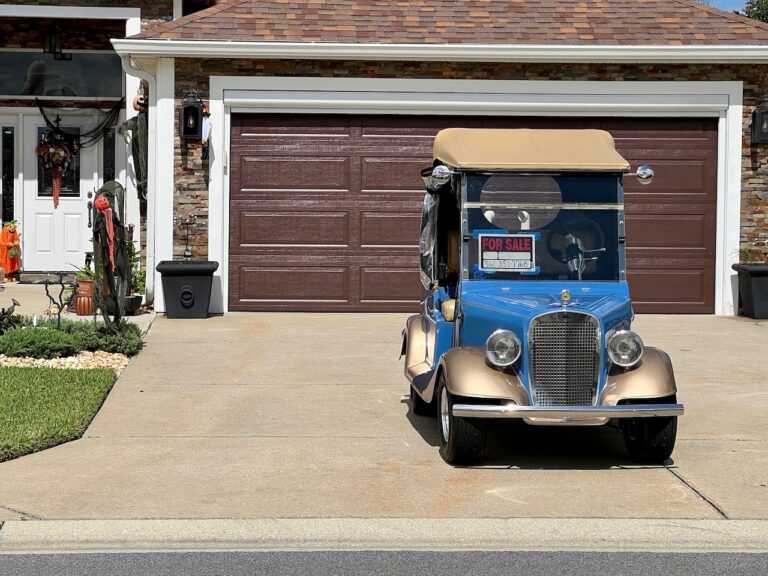 This golf cart with a a For Sale sign was in the driveway at the home at 3099 Southern Trace