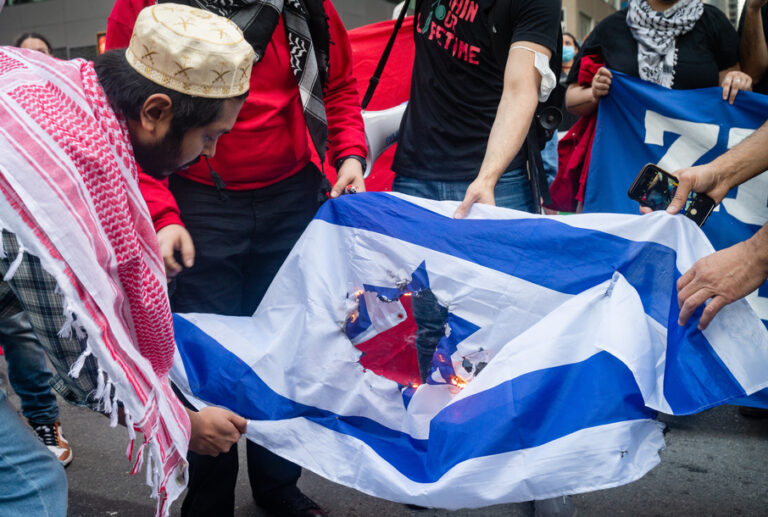 NEW YORK, UNITED STATES May 15, 2021: Pro Palestinian protesters burn Israeli flag in New York